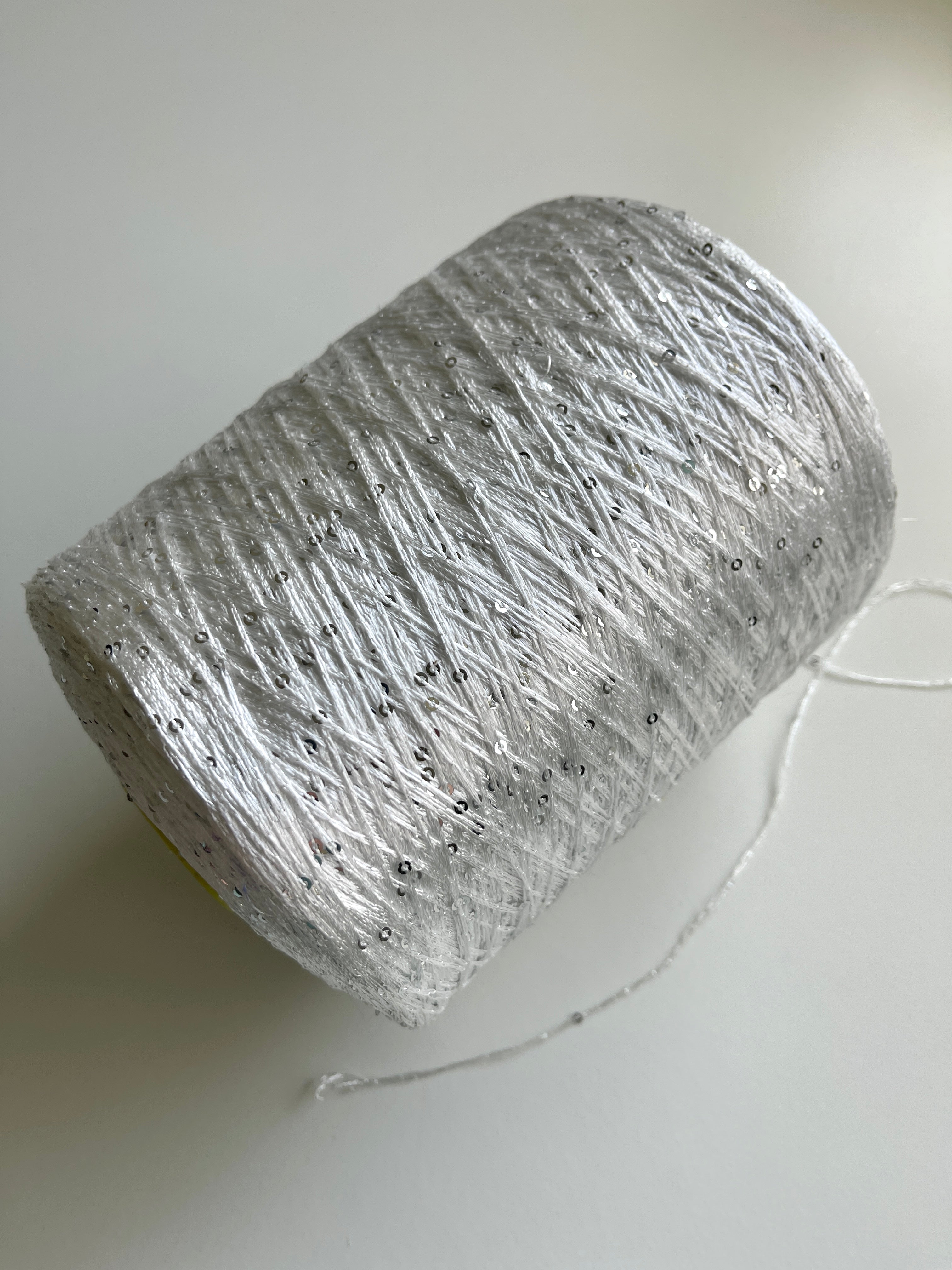 Sequins from Cofil on a cone (silver on white)